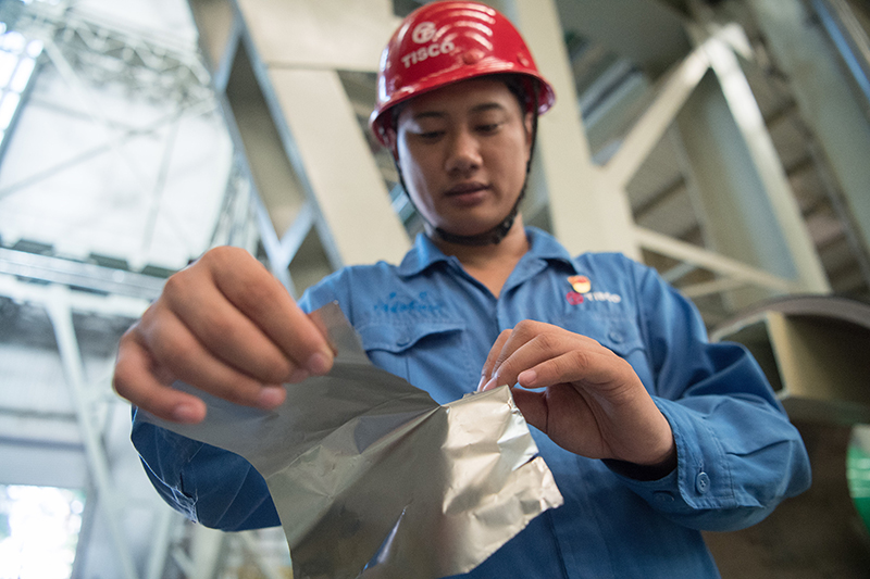 2018年8月8日，山西省太原市，太鋼精密帶鋼公司工作人員用手撕開不銹鋼。