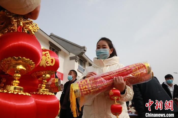 27日，蘭州新區(qū)為舟曲避險(xiǎn)搬遷移民送“春節(jié)包”，楊周馬草前往領(lǐng)取，紅色寓意來年的日子紅紅火火。　魏建軍 攝