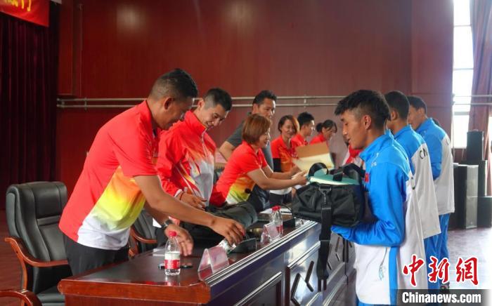 圖為世界冠軍們?yōu)槲鞑刈灾螀^(qū)體校的學(xué)生們送上暖心物資?！∪轿木?攝