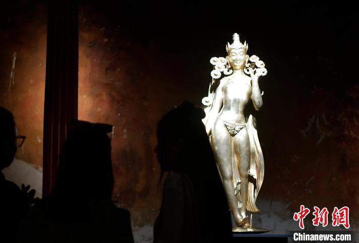 圖為觀眾正在欣賞展覽中的雕塑作品《八萬四千年》?！±盍?攝